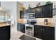 Well-lit kitchen featuring granite countertops, stainless steel appliances, and dark wood cabinetry at 249 Mill Slough Rd, Oviedo, FL 32766