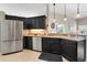 Contemporary kitchen boasting dark cabinets, granite countertops, and stainless steel appliances at 249 Mill Slough Rd, Oviedo, FL 32766