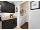 Convenient laundry room with washer, dryer, storage shelves, and exterior access at 249 Mill Slough Rd, Oviedo, FL 32766