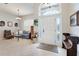 Bright living room featuring tile floors, a high ceiling, and a large front door with glass sidelights at 249 Mill Slough Rd, Oviedo, FL 32766