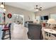 Spacious living room with tile flooring, ceiling fan, and views into the sunroom at 249 Mill Slough Rd, Oviedo, FL 32766