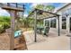 A covered patio features a dining table and chairs, as well as a swing, creating an inviting outdoor space at 249 Mill Slough Rd, Oviedo, FL 32766