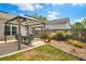 A backyard features a covered patio with dining, swing and manicured lawn, creating a relaxing outdoor atmosphere at 249 Mill Slough Rd, Oviedo, FL 32766