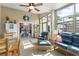 Bright sunroom with tile floors, comfortable seating, and views of the backyard and home interior at 249 Mill Slough Rd, Oviedo, FL 32766