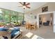 Comfortable sunroom with lots of natural light, tile floors, ceiling fan, and access to the backyard at 249 Mill Slough Rd, Oviedo, FL 32766