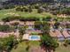An aerial view of houses with backyard pools and a manicured golf course at 2498 Saint Augustine Blvd, Haines City, FL 33844