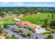 Panoramic aerial view of the clubhouse, golf course, and practice range with lush landscaping at 2498 Saint Augustine Blvd, Haines City, FL 33844