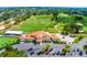 Inviting aerial view of clubhouse, golf course, and parking lot, showcasing the meticulously maintained grounds at 2498 Saint Augustine Blvd, Haines City, FL 33844