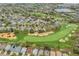 Desirable golf course community with houses, lush greenery, sand traps, and serene water features at 2498 Saint Augustine Blvd, Haines City, FL 33844