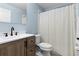 This bathroom features a vanity, toilet, and shower with curtain at 2498 Saint Augustine Blvd, Haines City, FL 33844