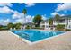Sparkling community pool surrounded by lounge chairs, palm trees, and well-maintained grounds at 2498 Saint Augustine Blvd, Haines City, FL 33844
