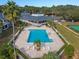Aerial view highlighting a community pool near the clubhouse, with surrounding greenery and facilities at 2498 Saint Augustine Blvd, Haines City, FL 33844