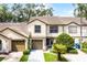 Inviting townhouse featuring a tile roof, two-car garage, and well-manicured landscaping at 2498 Saint Augustine Blvd, Haines City, FL 33844