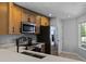 Bright kitchen with stainless steel appliances, light cabinets, and stone countertops at 2498 Saint Augustine Blvd, Haines City, FL 33844