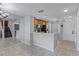 Modern kitchen with light colored cabinets and countertops adjacent to a staircase at 2498 Saint Augustine Blvd, Haines City, FL 33844