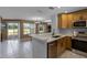 Modern kitchen with stainless steel appliances and quartz countertops overlooks the dining and living area at 2498 Saint Augustine Blvd, Haines City, FL 33844