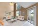 Bright living room featuring high ceilings, neutral walls, and a sliding glass door to the screened patio at 2498 Saint Augustine Blvd, Haines City, FL 33844