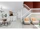 Open-concept living space featuring light walls, a staircase, dining area and adjacent kitchen at 2498 Saint Augustine Blvd, Haines City, FL 33844