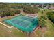 Aerial view of well-maintained tennis courts and playground in a lush, green community setting at 2498 Saint Augustine Blvd, Haines City, FL 33844
