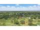 Aerial view of a property nestled on a golf course with surrounding trees and a pin drop at 2756 Summerfield Rd, Winter Park, FL 32792