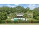 Aerial view of the backyard featuring a pool, spa, manicured lawn, and landscaping, surrounded by lush trees at 2756 Summerfield Rd, Winter Park, FL 32792