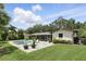 Backyard featuring a screened-in porch, a pool, a jacuzzi, and beautiful landscaping and plants at 2756 Summerfield Rd, Winter Park, FL 32792