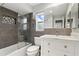 Modern bathroom features a tiled shower-tub and vanity with marble countertop at 2756 Summerfield Rd, Winter Park, FL 32792