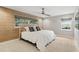 Serene bedroom with a wood accent wall, plush bedding, and a ceiling fan at 2756 Summerfield Rd, Winter Park, FL 32792