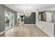 Open-concept dining area with hardwood floors, a modern light fixture, and sliding glass doors to the patio at 2756 Summerfield Rd, Winter Park, FL 32792