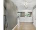Bright foyer featuring hardwood flooring, modern light fixtures, and an open view into the adjacent living spaces at 2756 Summerfield Rd, Winter Park, FL 32792