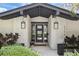 Stylish front entrance with modern lighting, a decorative brick surround, and elegant planters for a welcoming feel at 2756 Summerfield Rd, Winter Park, FL 32792
