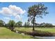 Scenic view of a golf course with a small creek and wooden bridge, surrounded by lush greenery and mature trees at 2756 Summerfield Rd, Winter Park, FL 32792