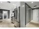 Well-equipped kitchen featuring stainless steel appliances, white cabinetry, and a view into the hallway at 2756 Summerfield Rd, Winter Park, FL 32792