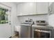 Bright laundry room with sink and stainless steel washer and dryer at 2756 Summerfield Rd, Winter Park, FL 32792