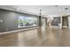 Spacious living area featuring hardwood flooring, a modern chandelier, and a large window with an exterior view at 2756 Summerfield Rd, Winter Park, FL 32792