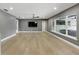 Expansive living room with hardwood floors, modern lighting, and large windows providing views to the outdoors at 2756 Summerfield Rd, Winter Park, FL 32792