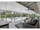 Covered patio offers comfortable seating and a view of the backyard pool and spa at 2756 Summerfield Rd, Winter Park, FL 32792