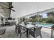 Covered patio with a dining table and view of the fenced-in pool and spa at 2756 Summerfield Rd, Winter Park, FL 32792