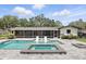 Relaxing pool with a spa and comfortable lounge chairs in a screened-in patio at 2756 Summerfield Rd, Winter Park, FL 32792