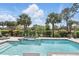 Sparkling pool with lush landscaping and a black iron fence at 2756 Summerfield Rd, Winter Park, FL 32792