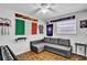 Fun bedroom is decorated with sports memorabilia, and has wood floors and a ceiling fan at 2859 T C U Blvd, Orlando, FL 32817