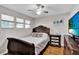 This cozy bedroom includes wood floors, a ceiling fan, and ample natural light at 2859 T C U Blvd, Orlando, FL 32817
