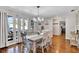 Bright dining room featuring hardwood floors, a modern chandelier, and large windows at 2859 T C U Blvd, Orlando, FL 32817