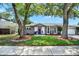 Charming home featuring a well-maintained front yard and a bright purple door at 2859 T C U Blvd, Orlando, FL 32817