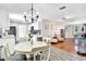 Open-concept kitchen with white cabinets, a black chandelier, and modern flooring at 2859 T C U Blvd, Orlando, FL 32817