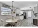 Bright kitchen with updated cabinets, black appliances, and modern gray flooring at 2859 T C U Blvd, Orlando, FL 32817