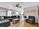 Comfortable living room with hardwood floors, open to a modern kitchen and dining area at 2859 T C U Blvd, Orlando, FL 32817