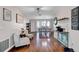 Cozy living room with hardwood floors, lots of decor, and views into the dining room at 2859 T C U Blvd, Orlando, FL 32817