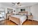 Bright main bedroom features wood floors, a ceiling fan, and neutral décor at 2859 T C U Blvd, Orlando, FL 32817