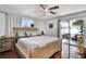 Spacious main bedroom with wood-look floors, a ceiling fan, and a patio entrance at 2859 T C U Blvd, Orlando, FL 32817